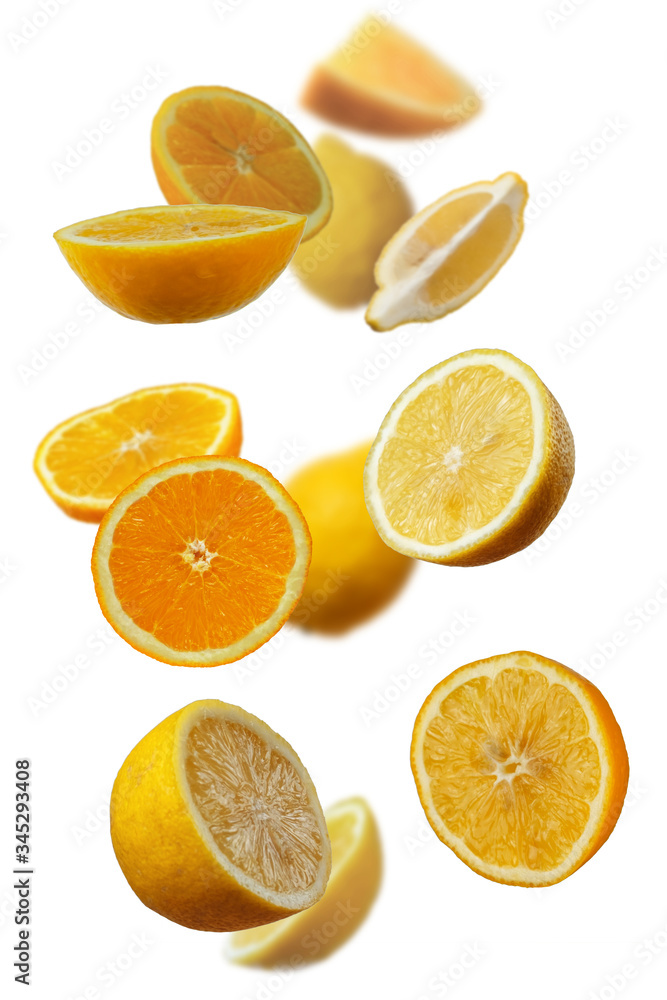 Falling fresh mixed citruses. Slices of the lemon and orange the air. Flying fruits concept