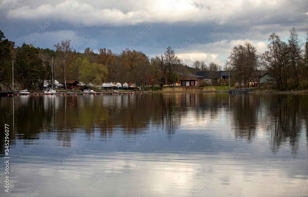 Boat station and lakeside houses under a cloudy spring sky
Boat station and lakeside houses under a cloudy spring sky
