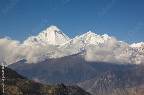 Spectacular panorama of Mount Dhaulaghiri in the himalayas of Nepal. Pyramid-shaped mount completely covered in snow and ice. Annapurnas round trek