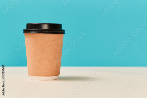 Blank paper cup mockup for creative design, copy space. Paper glass with plastic cap. Take away morning coffee concept