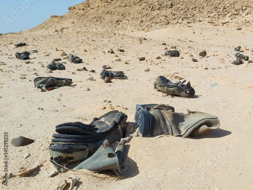 Old military army boots abandoned in remote african desert