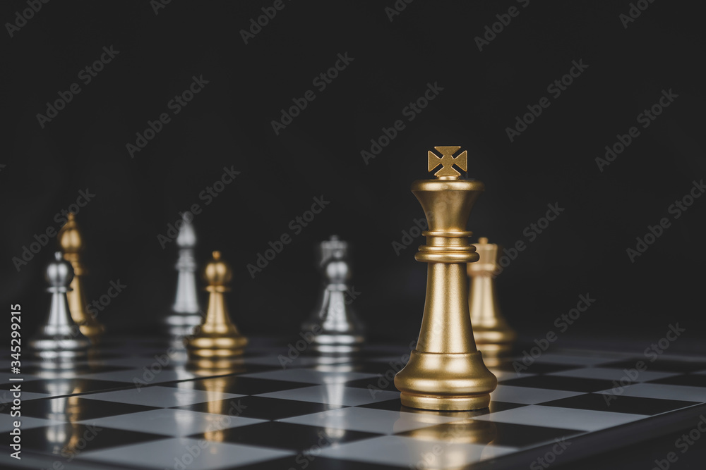 Leader. gold king with silver chess pieces on chess board game competition on dark background, business plan, chess battle, victory, success, team leader, teamwork and business strategy concept Leader. gold king with silver chess pieces on chess board game competition on dark background, business plan, chess battle, victory, success, team leader, teamwork and business strategy concept
