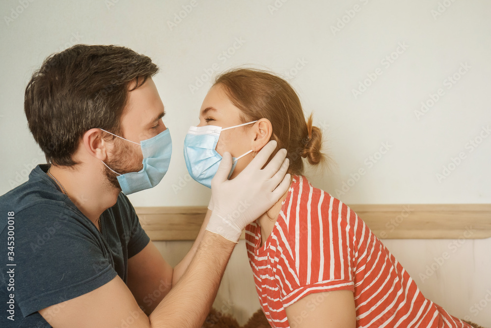 young couple in protection masks kissing each other, young woman and man kiss during epidemic young couple in protection masks kissing each other, young woman and man kiss during epidemic