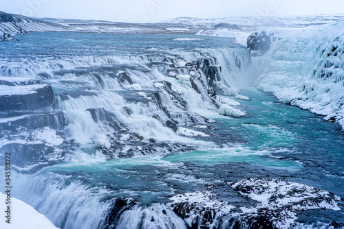 Gulfoss in Icelands Interior, snow covered waterfalls. photo