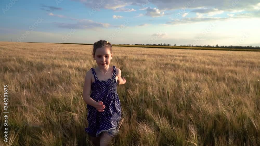 Girl runs across the field with wheat in summer, slow motion Girl runs across the field with wheat in summer, slow motion