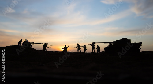 War Concept. Military silhouettes fighting scene on war fog sky background, World War Soldiers Silhouette Below Cloudy Skyline At sunset.