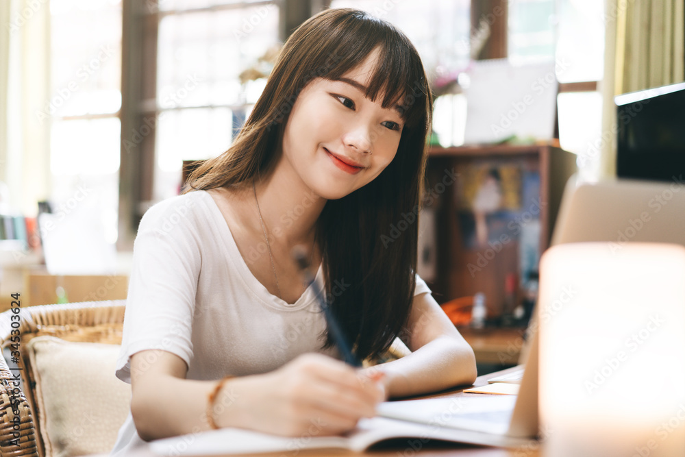 Asian teenager woman stay at home use internet for work and study Asian teenager woman stay at home use internet for work and study