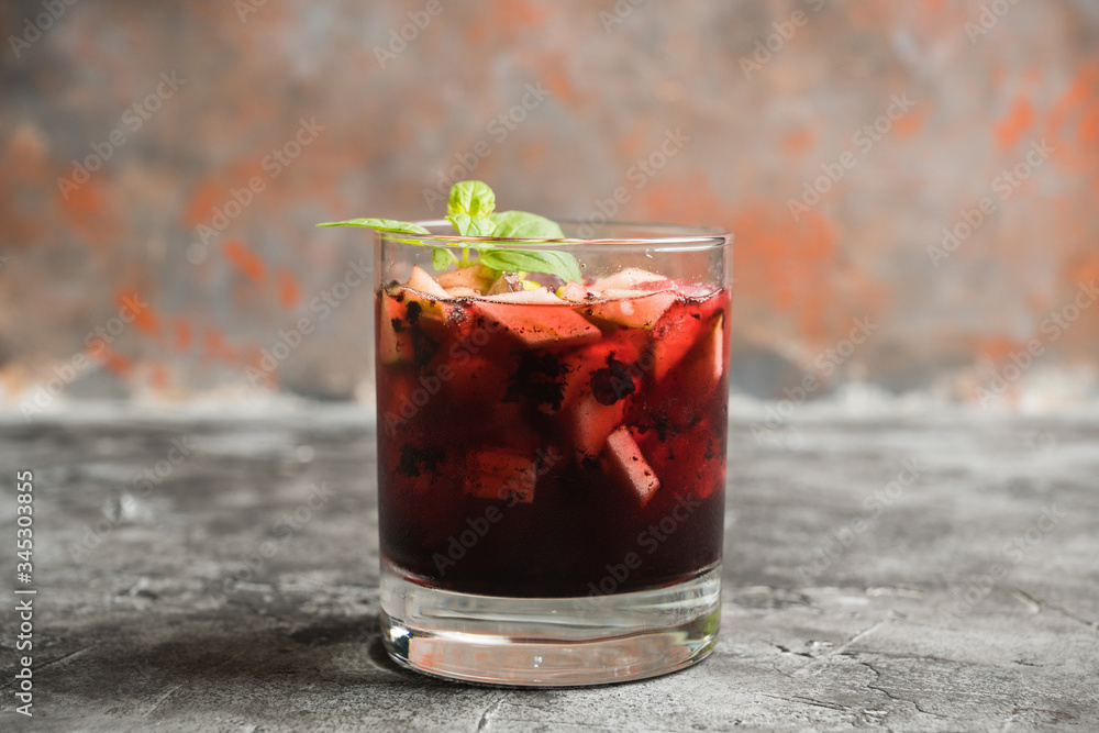 Old fashioned cocktail with blackberry liqueur and apple slices on rustic background. Selective focus. Shallow depth of field. Old fashioned cocktail with blackberry liqueur and apple slices on rustic background. Selective focus. Shallow depth of field.