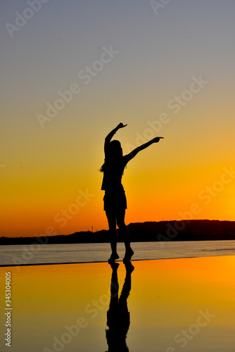 silhouette of a girl with reflection in an infinity pool at sunset. Egypt 2020