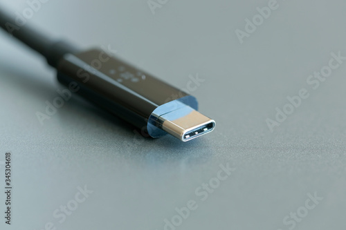 Type-C cable connector with close-up on a gray background photo