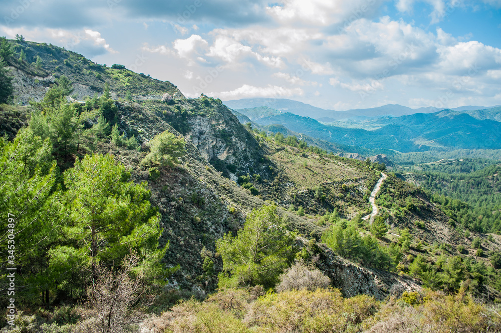 Light clouds cast fancy shadows on the peaks and slopes of the Troodos Mountains. Shadows creep from mountain to mountain, changing their shape.         