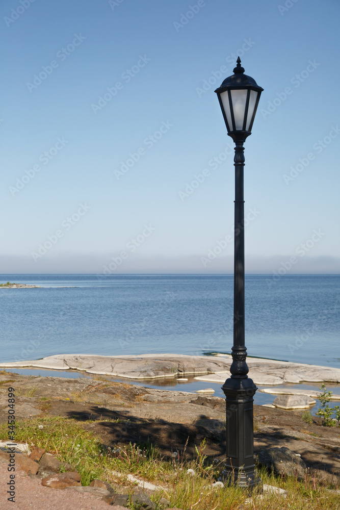 Lamppost on the shore of Lake Ladoga on the island of Valaam on a sunny day.