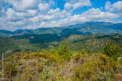 Light clouds cast fancy shadows on the peaks and slopes of the Troodos Mountains. Shadows creep from mountain to mountain  changing their shape.         