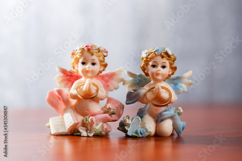 Ceramic angels. Figurines angels. Gold wedding rings