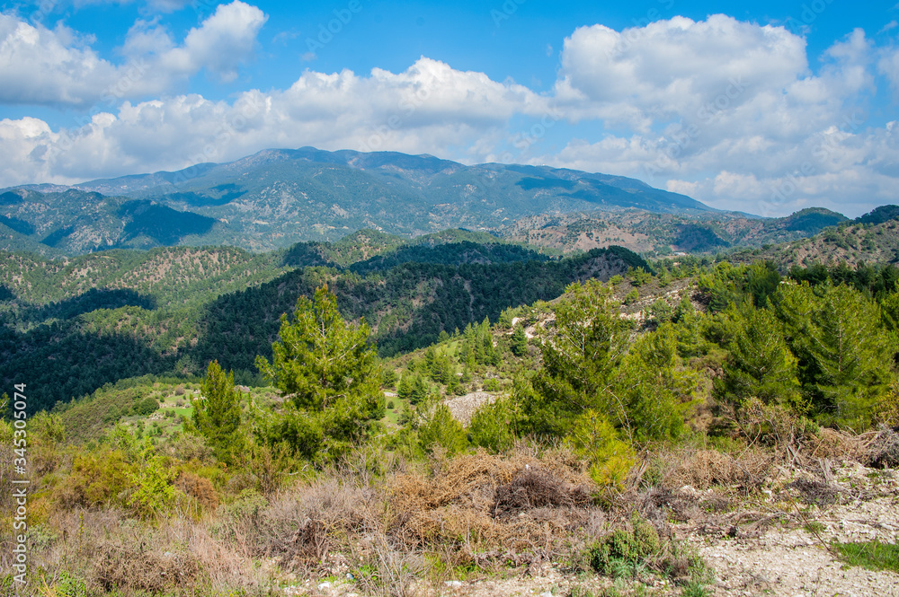 Light clouds cast fancy shadows on the peaks and slopes of the Troodos Mountains. Shadows creep from mountain to mountain, changing their shape. Light clouds cast fancy shadows on the peaks and slopes of the Troodos Mountains. Shadows creep from mountain to mountain, changing their shape.