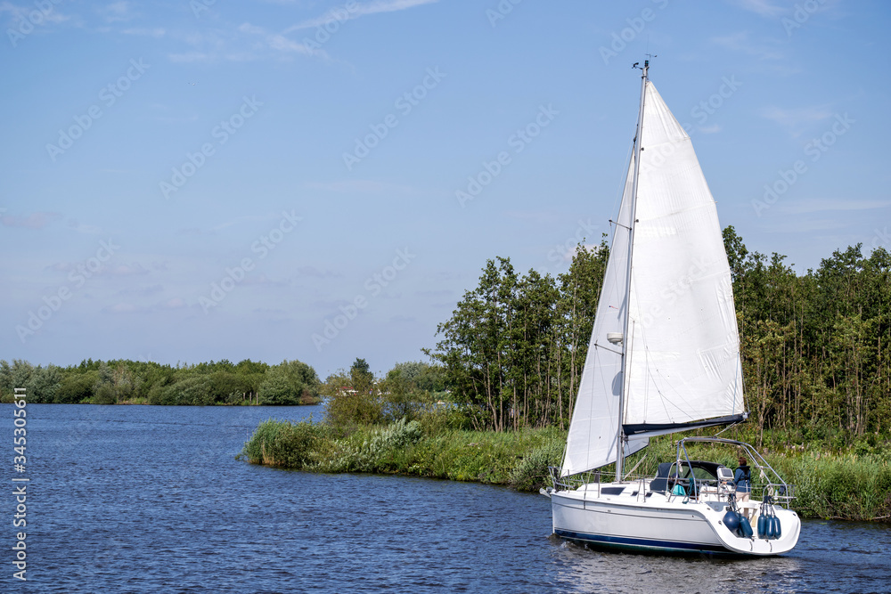 Obraz premium sailing boat in Dutch waterscape
