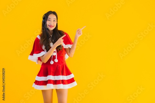 Portrait beautiful young asian woman wear christmas clothes and hat with headphone