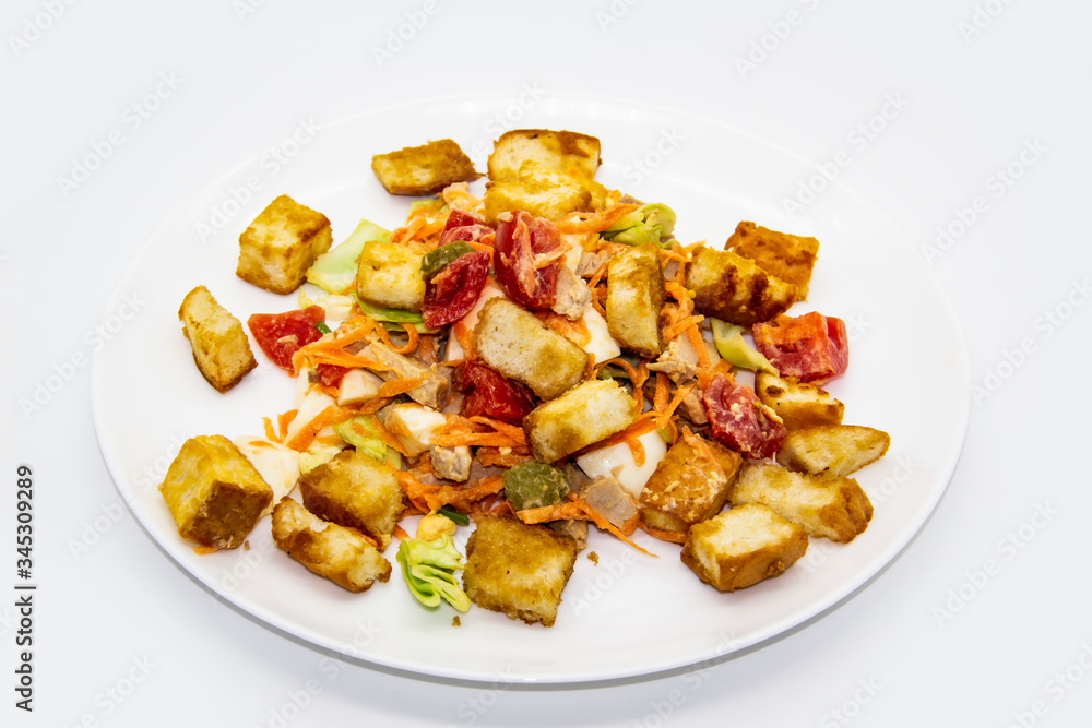 Salad with meat of pig, tomatoes, carrots, cabbage and crackers with bread runner with sauce on the white plate. Healthy and tasty meal for the diet. Delicious breakfast or lunch without GMO Salad with meat of pig, tomatoes, carrots, cabbage and crackers with bread runner with sauce on the white plate. Healthy and tasty meal for the diet. Delicious breakfast or lunch without GMO