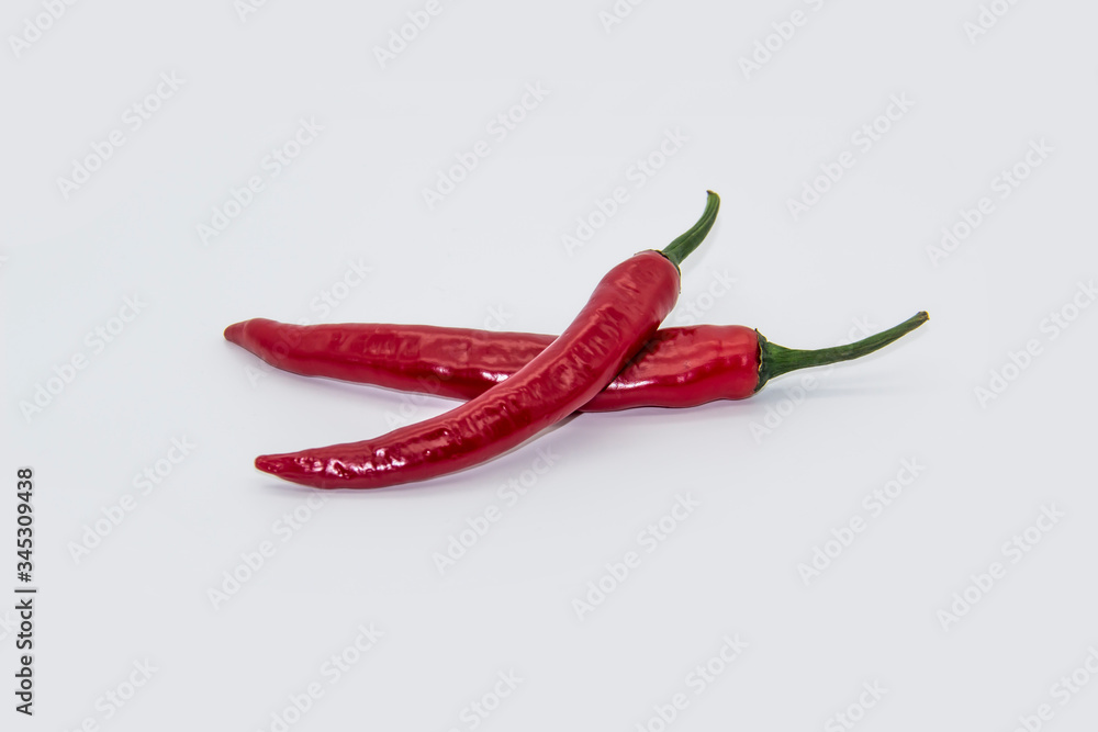 Two Chili peppers isolated on white background. Hot ripen chili peppers without GMO. Organic mexican spices