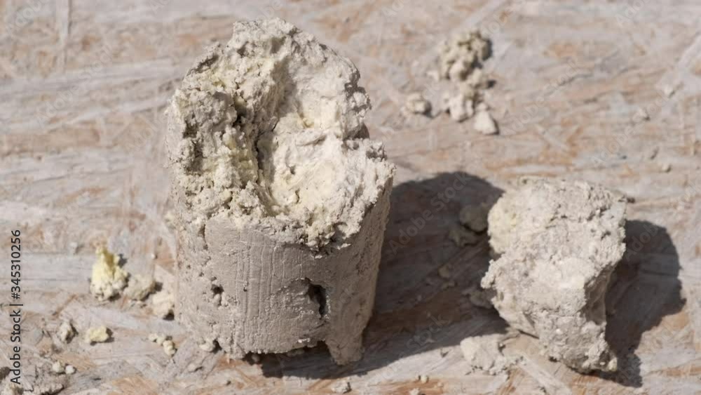 A large piece of compressed grease and dirt, which was removed from the sewer. Close-up. A large piece of compressed grease and dirt, which was removed from the sewer. Close-up.