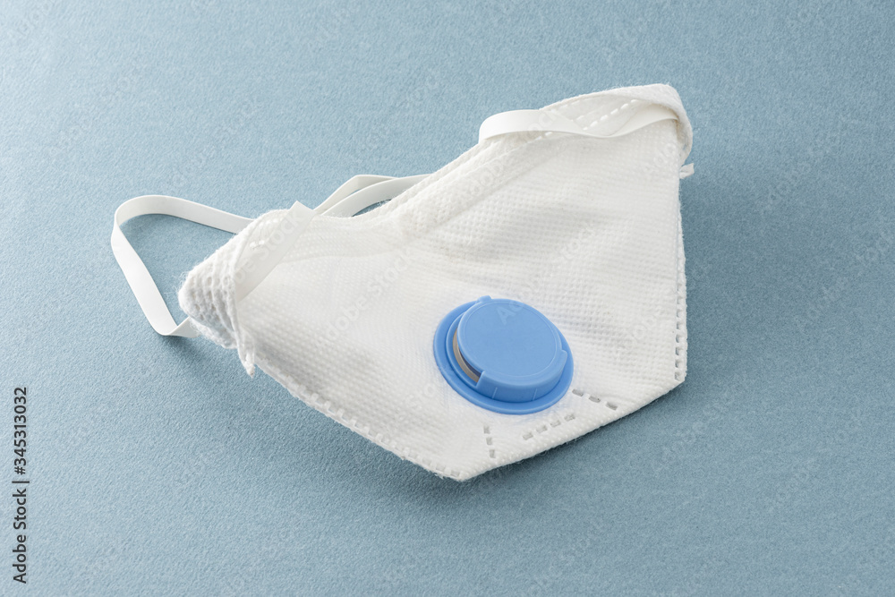 Protective face mask on the blue background. Protective face mask on the blue background.