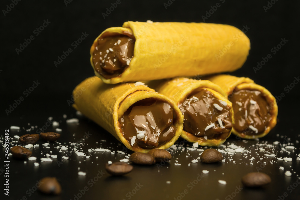Wafer rolls with condensed milk on a white plate. Wafer rolls with condensed milk on a white plate.