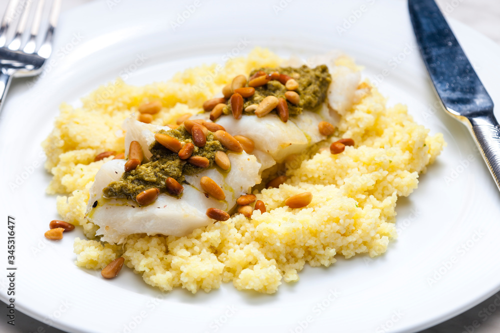 cod with green pesto and pine seeds with couscous