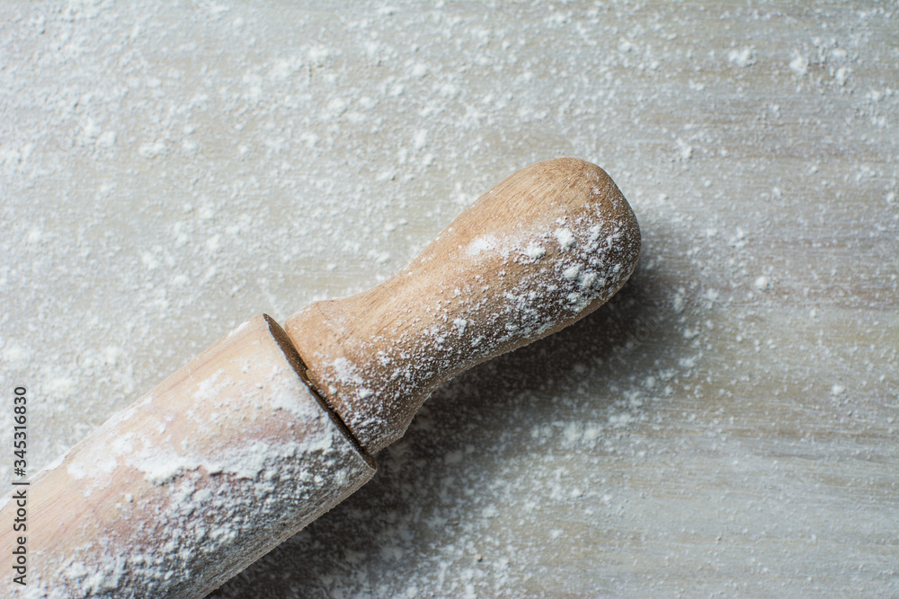 Fototapeta premium Rolling Pin and Flour on Light Background