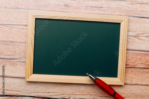 Clean vintage chalk board on a wooden table.