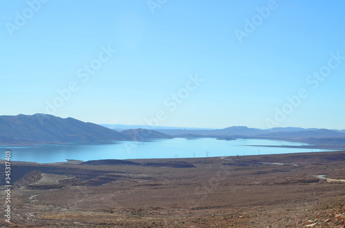 Water Reservoir in Atlas mountain with inscription on the dam: Allah, The King, Native Land. Morocco