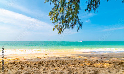 Fototapeta Naklejka Na Ścianę i Meble -  View from tropical beach at Koh Lanta island, Thailand. View to pure sea with boats and yacht on water. Look from shadow of tree on sand beach. Summer paradise, vibrant colors, tropical exotic place