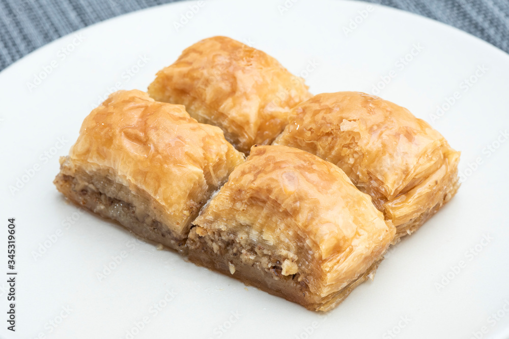 Turkish Ramadan Dessert Baklava isolated on beige plate.