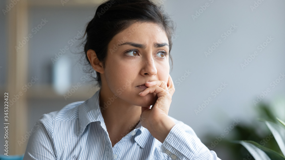 Head shot close up sad young indian woman thinking of problems, looking away. Unhappy millennial hindu girl student suffering from personal professional troubles, feeling depressed at home. Head shot close up sad young indian woman thinking of problems, looking away. Unhappy millennial hindu girl student suffering from personal professional troubles, feeling depressed at home.