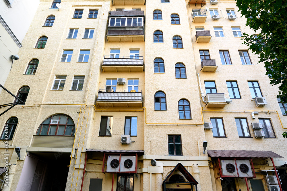 Multi-storey yellow residential building in center of Moscow. View from yard