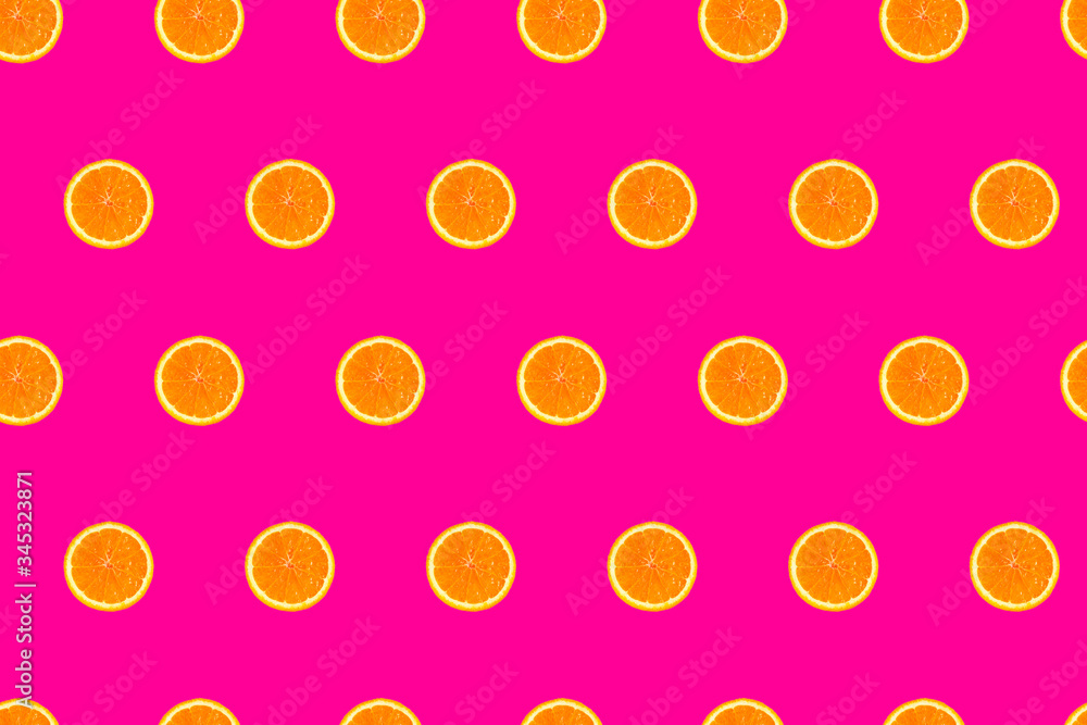 sliced orange halves on pink seamless pattern