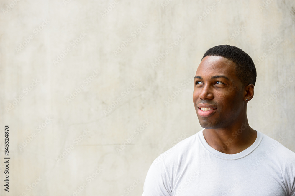 Obraz premium Face of happy young handsome African man thinking