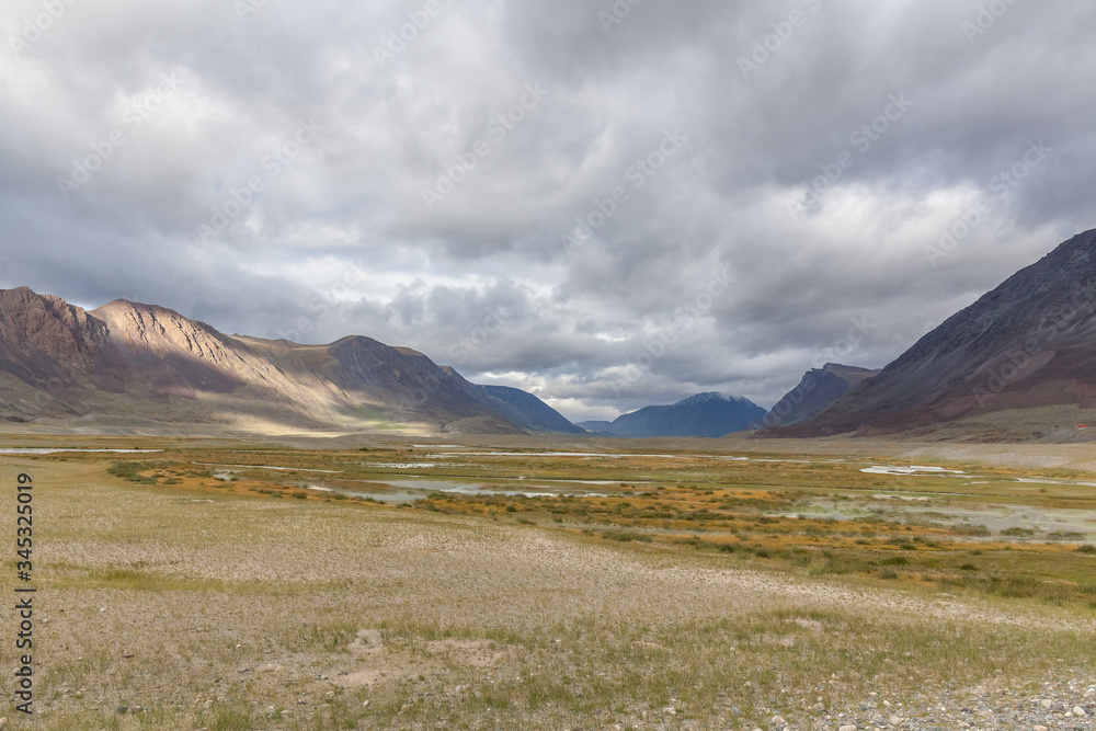 Landscape of valley in rolling hills of Western Mongolian steppe Landscape of valley in rolling hills of Western Mongolian steppe