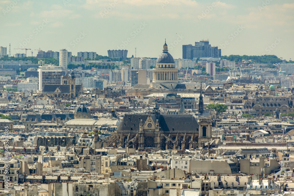 PARIS, FRANCE - JUNE 23, 2016: Aerial view from Basilica of the Sacred Heart of Jesus stands at the summit of the butte Montmartre - highest point in the Paris. Telephoto lens shot