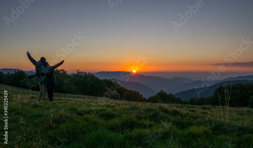 Sunrise over mountain at ballon d Alsace. People cheering and enjoying the view. France.