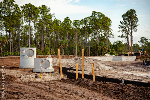Concrete sewer pipes waiting to be installed at a new housing subdivision in southwest Florida.