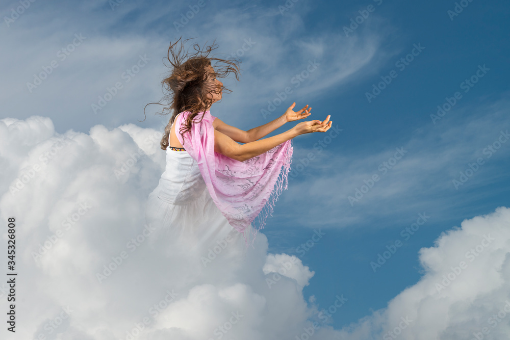 Young girl praying in the clouds Young girl praying in the clouds