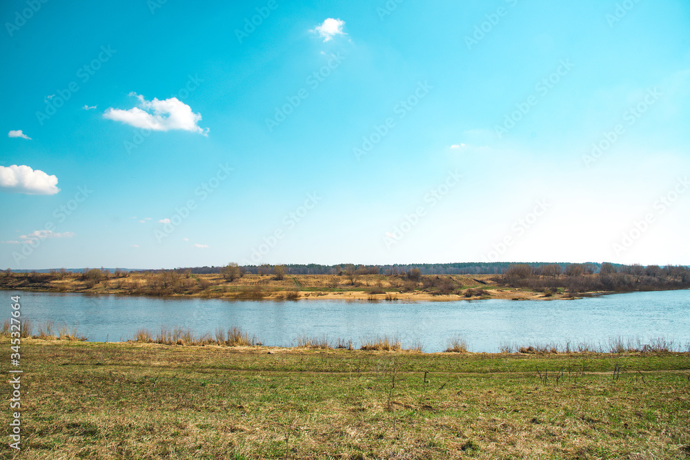 Spring landscape with blue sky, river and meadow Spring landscape with blue sky, river and meadow