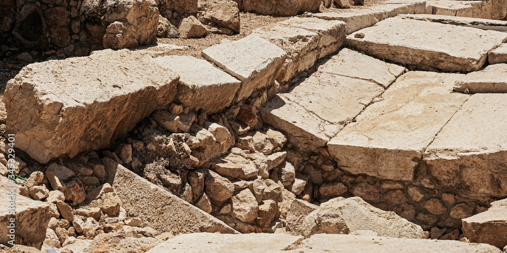 Fototapeta premium closeup detail of the dressed stones of the herodian roman street next to the ancient western wall kotel of the second temple in jerusalem