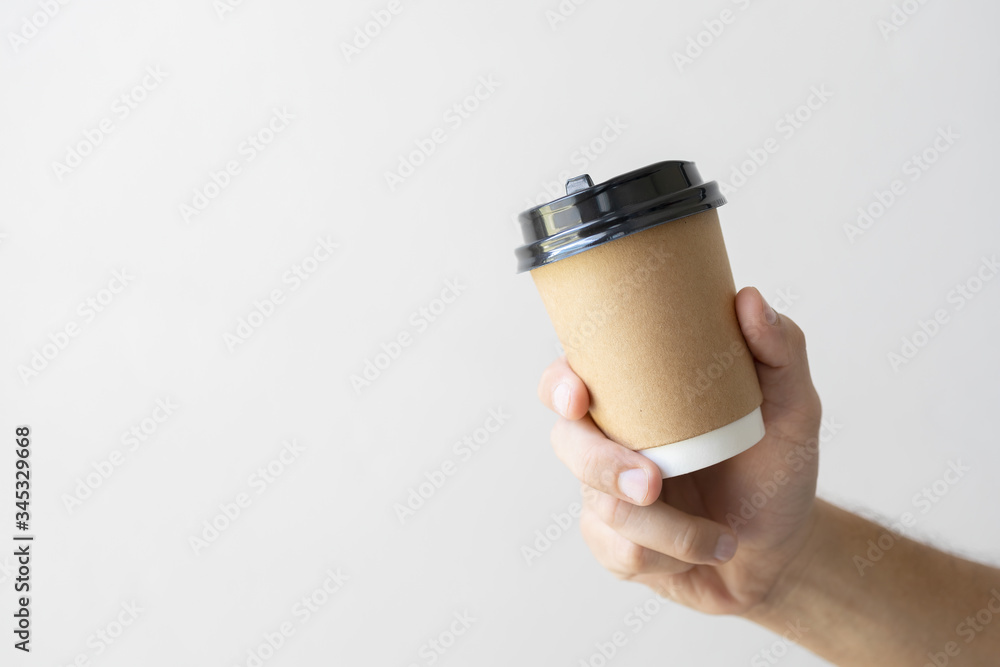 Close-up of Male Hands Holding a Paper Coffee Cup and Holder for