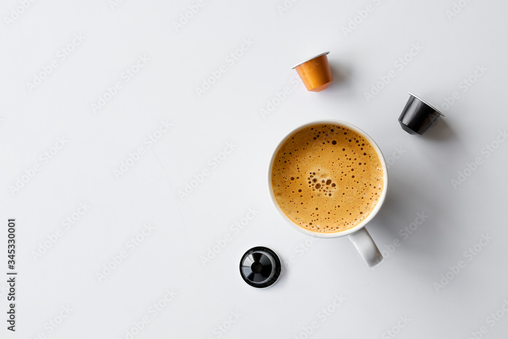 hot coffee cup and capsules on white background hot coffee cup and capsules on white background
