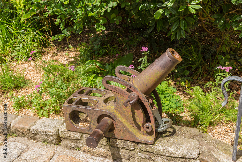 Dinan, France. Small old mortar in the courtyard of the clock tower