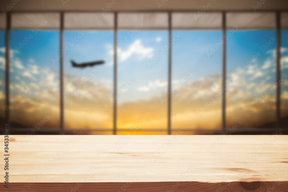 Empty wooden desk space and blurry background of airport for product display montage. Empty wooden desk space and blurry background of airport for product display montage.