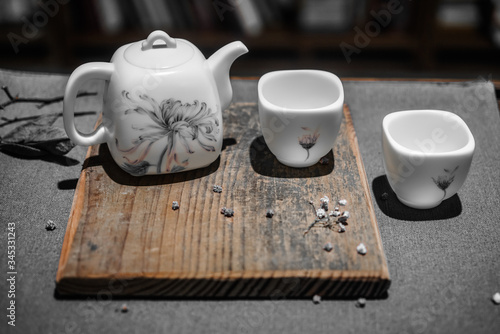 White ceramic tea set. Tea ware for traditional tea ceremony. Teapot and cups with flower pattern