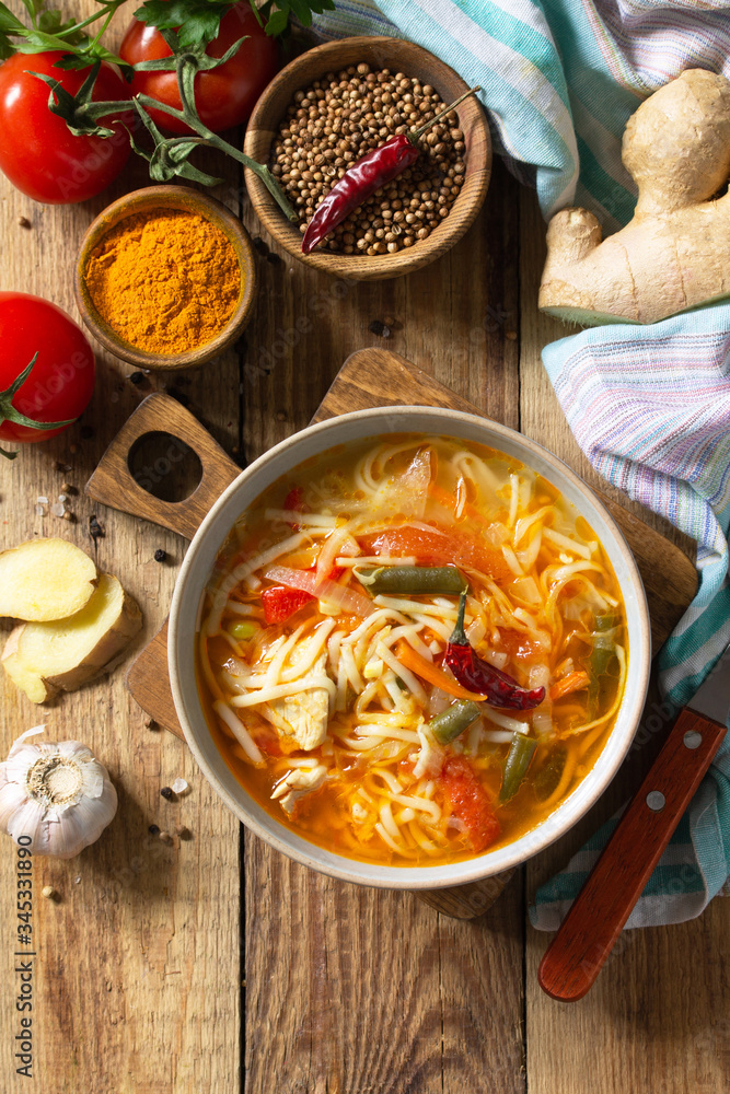 Tukpa soup of Indian cuisine. Hot noodle soup with chicken, ginger, cilantro and spices on a deyven wooden table. Top view flat lay background. Copy space. Tukpa soup of Indian cuisine. Hot noodle soup with chicken, ginger, cilantro and spices on a deyven wooden table. Top view flat lay background. Copy space.