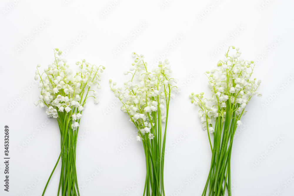 Bouquets of lilies of the valley on a white background, top view of mayflower
